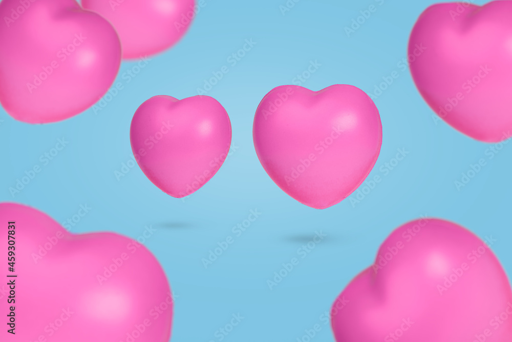 Creative idea with floating hearts in the air on pastel blue background.