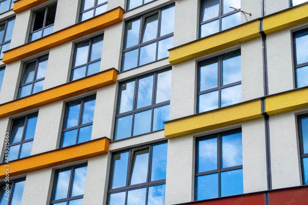 Wall of a modern new building with windows. Beautiful juicy colored building texture for background Wall of a modern new building with windows. Beautiful juicy colored building texture for background