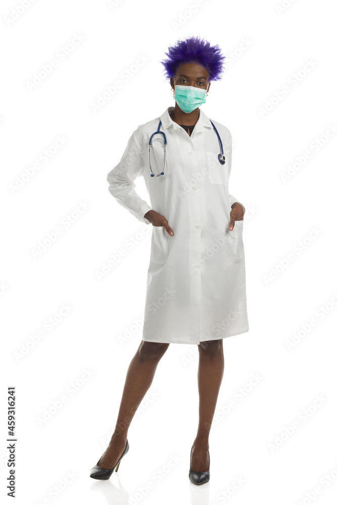 Black Female Doctor In Protective Face Mask Is Standing With Hands In Pockets. Full Length, Isolated. Black Female Doctor In Protective Face Mask Is Standing With Hands In Pockets. Full Length, Isolated.