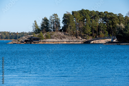 A view of the Finnish archipelago. A small sauna building with connecting bridges in an island.