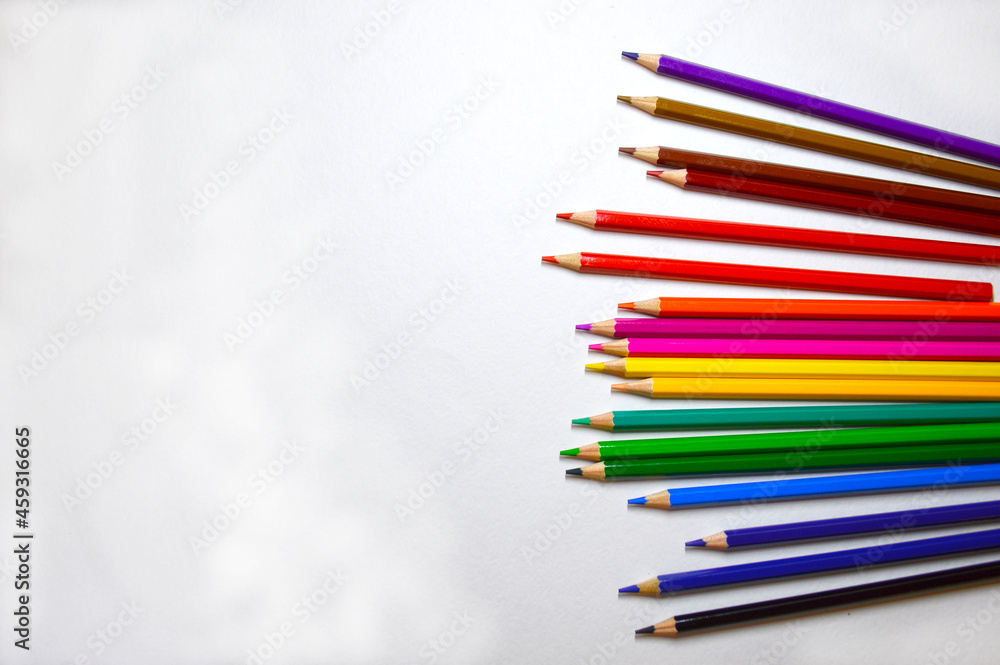 Fototapeta premium wooden multicolored pencils are lined with a fan in a chaotic order on a white background. art and education development concept