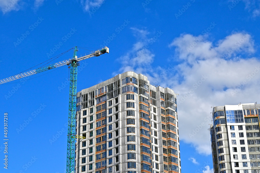 Crane and highrise construction site Crane and highrise construction site