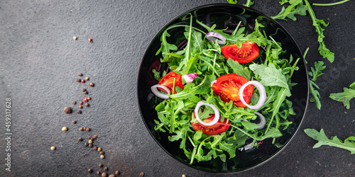 arugula and tomato salad vegetable in a plate fresh portion ready to eat meal snack on the table copy space food background rustic. top view keto or paleo diet veggie vegan or vegetarian food