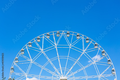 A large white Ferris wheel against the blue sky on a sunny summer day. Rostov-on-Don.