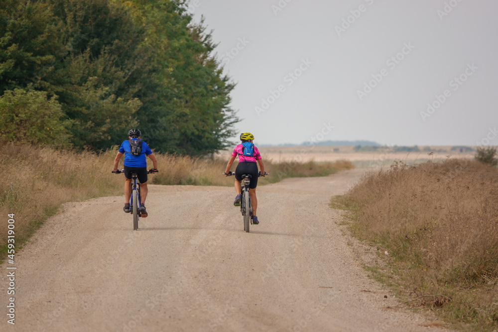 a pair of casual cyclists on a stone track crossing salisbury plain, Wiltshire UK