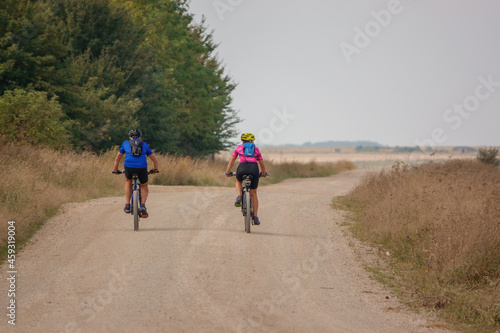 a pair of casual cyclists on a stone track crossing salisbury plain, Wiltshire UK