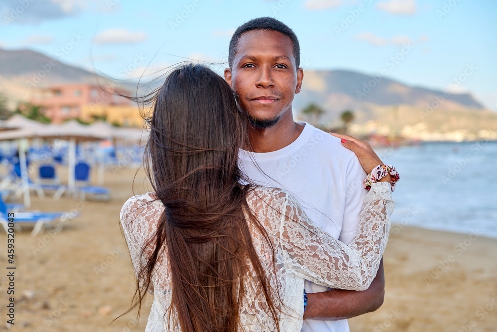 Happy young couple hugging, man's face close up