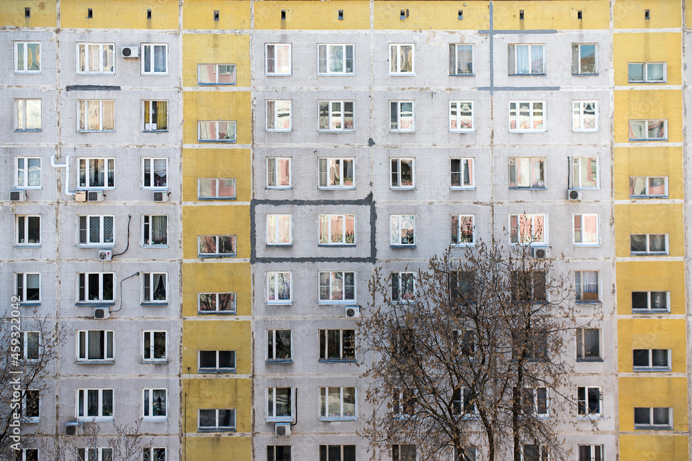 Fototapeta premium The facade of a nine-storey block house with yellow stripes. Moscow