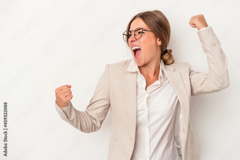 Young Russian business woman isolated on white background raising fist after a victory, winner concept. Young Russian business woman isolated on white background raising fist after a victory, winner concept.