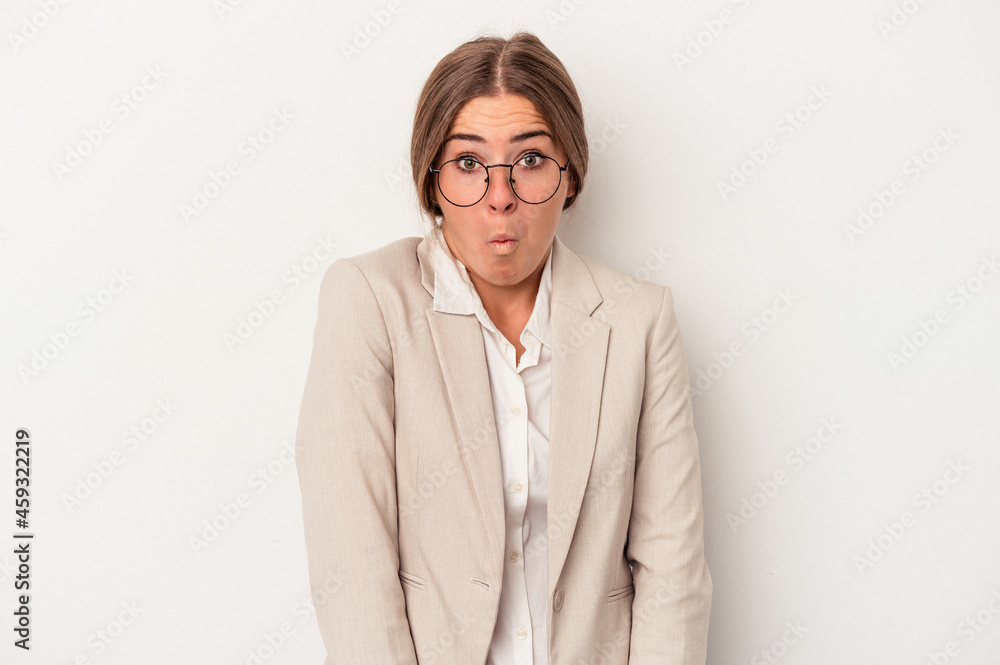 Young Russian business woman isolated on white background shrugs shoulders and open eyes confused. Young Russian business woman isolated on white background shrugs shoulders and open eyes confused.