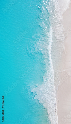 Top view of the beautiful ocean shore with waves and foam on the sand. Seychelles. Texture and background tourism design © Payllik