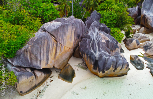 Top view of a summer ocean beach in the seychelles. Rocks and stones