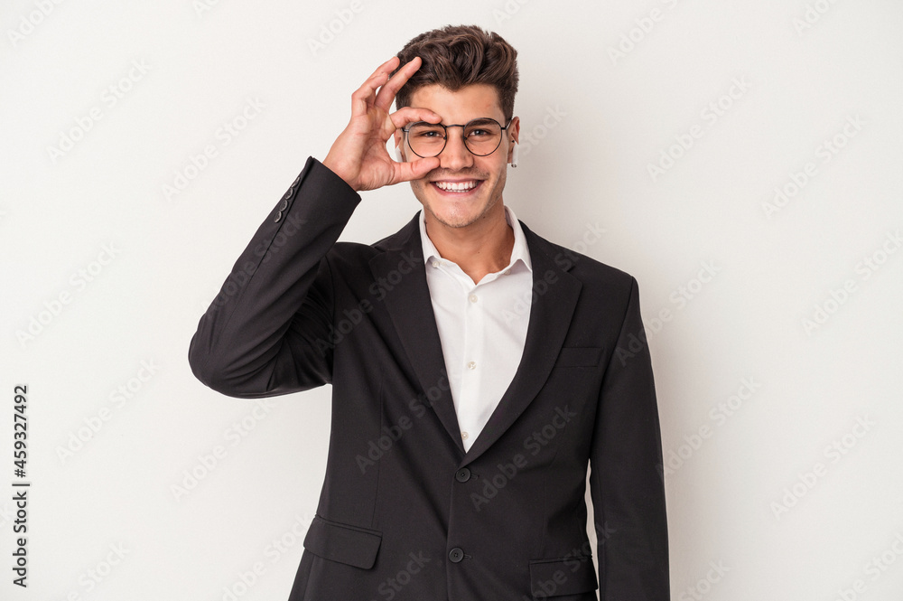 Young business caucasian man wearing headphones isolated on white background excited keeping ok gesture on eye. Young business caucasian man wearing headphones isolated on white background excited keeping ok gesture on eye.