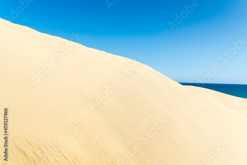 Blue sky and sand dunes in sunny day.