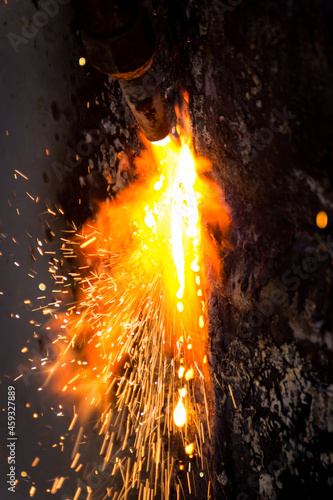 A worker welds a metal structure.