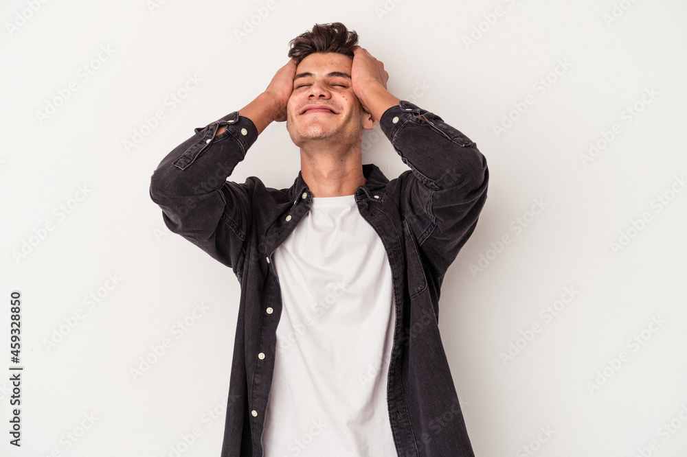 Young caucasian man isolated on white background laughs joyfully keeping hands on head. Happiness concept. Young caucasian man isolated on white background laughs joyfully keeping hands on head. Happiness concept.