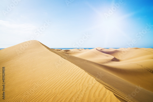 Blue sky and sand dunes in sunny day.