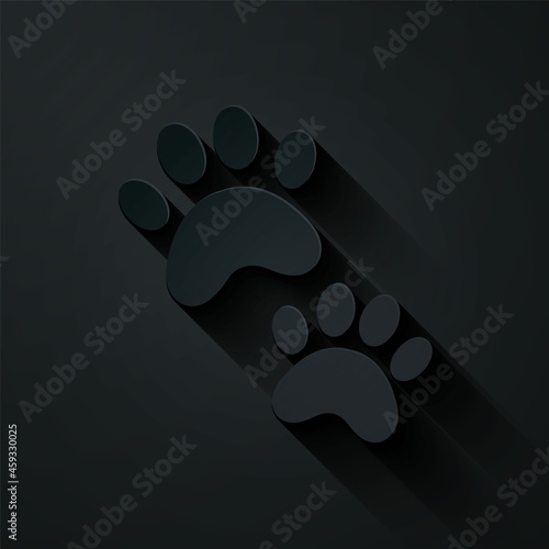 Paper cut Paw print icon isolated on black background. Dog or cat paw print. Animal track. Paper art style. Vector
