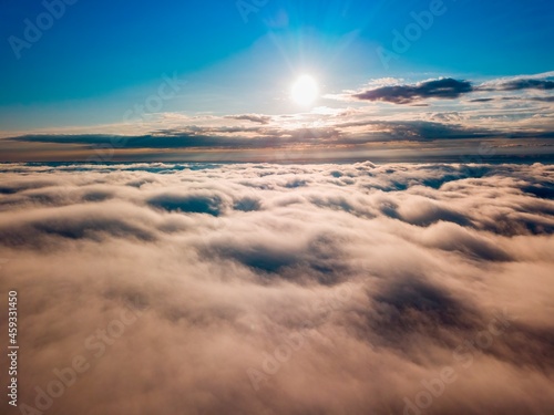 High flight over the fog in the mountains. Ukrainian Carpathians in the morning. Aerial drone view.