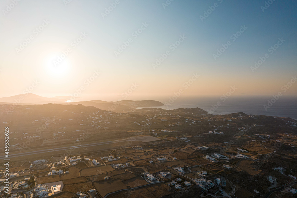 Aerial View of Sun Setting on the Horizon in Mykonos Greece Aerial View of Sun Setting on the Horizon in Mykonos Greece
