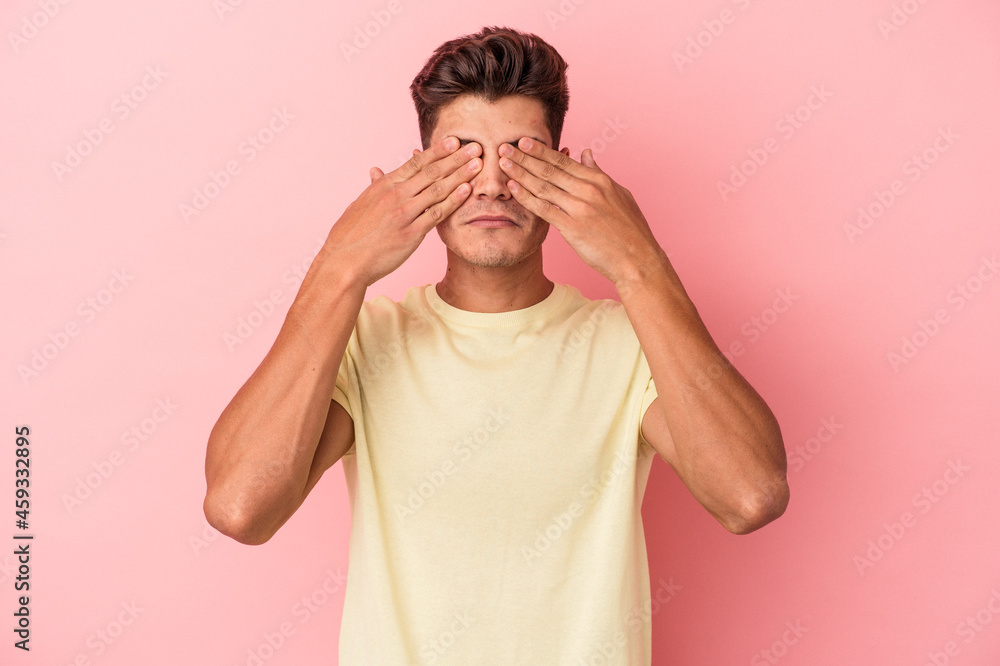 Young caucasian man isolated on pink background afraid covering eyes with hands. Young caucasian man isolated on pink background afraid covering eyes with hands.