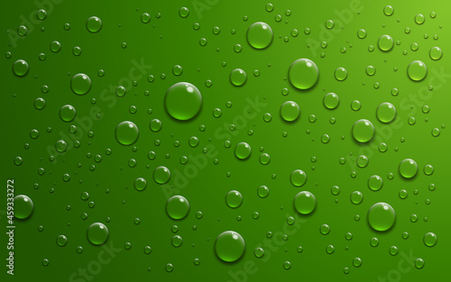Realistic water drops on green background