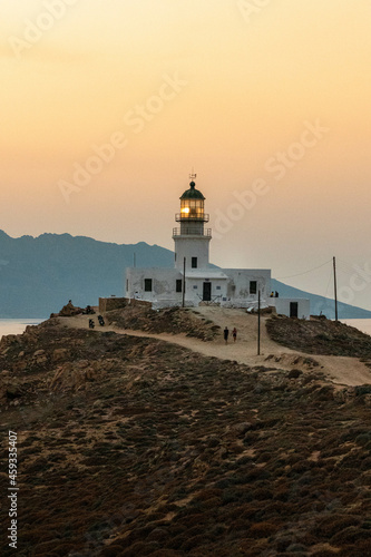 Lighthouse on the Coastline at Sunset in Mykonos Greece © suraju