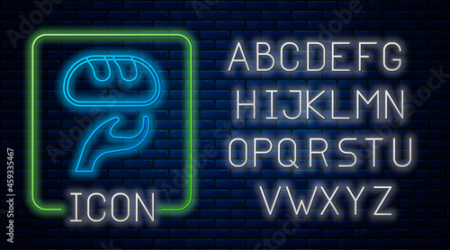 Glowing neon Donation food icon isolated on brick wall background. Neon light alphabet. Vector