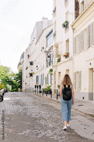 Tourist with a backpack walking by the streets of Paris