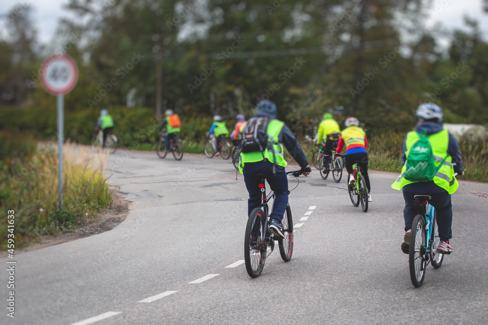 View of bicycle race in the city streets, bike race with a group mass of cyclist athletes in cycling competition, team of bikers on a urban bike path