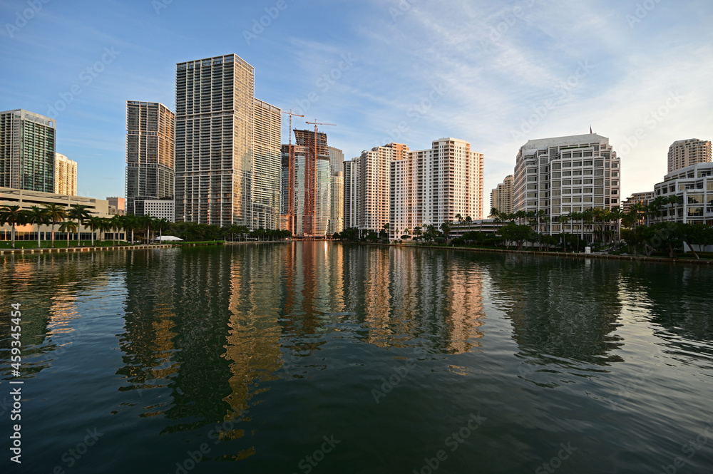 City of Miami, Florida skyline reflected in still water of Biscayne Bay at sunrise. City of Miami, Florida skyline reflected in still water of Biscayne Bay at sunrise.