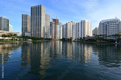 City of Miami  Florida skyline reflected in still water of Biscayne Bay at sunrise.