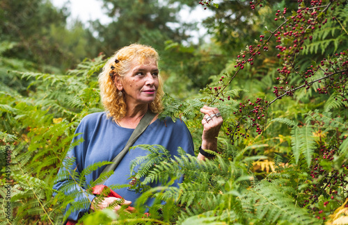 Woman with vitiligo standing in fern field