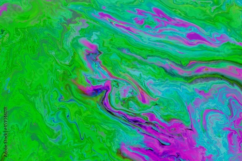 Abstract pink-green marble background. Acrylic paint mixes freely and creates an interesting pattern. Bright saturated shades. Background for the cover of a laptop, book.