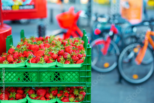Crates of fresh ripe strawberries on grocery store shelves