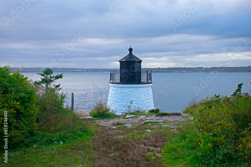 Castle Hill lighthouse in Newport, Rhode Island, overlooking Narragansett Bay from a rocky shoreline -08