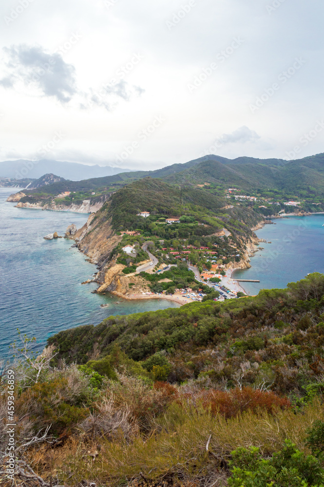 Aerial view of the northern little peninsula in Elba island seen from the top of Monte Enfola, typical mediterranean vegetation and rocky landscape