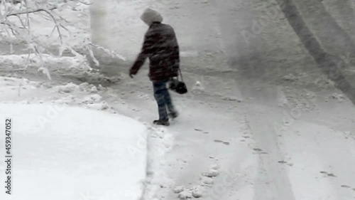 person walking in snow storm photo