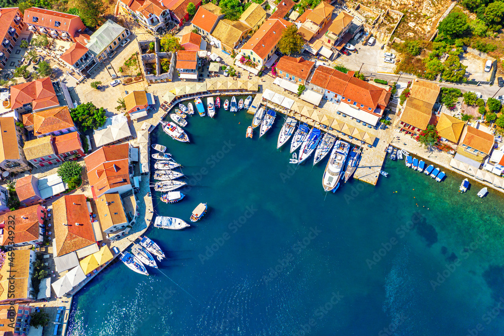 FAerial drone view of Fiscardo village port with luxury boats and yachts on Kefalonia island, Greece.