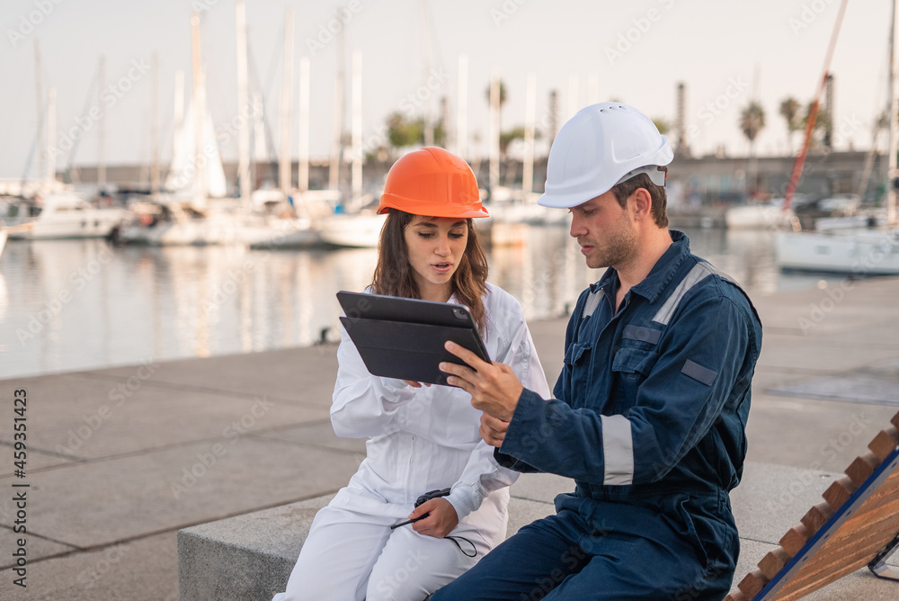 Port managers with tablet discussing project Port managers with tablet discussing project