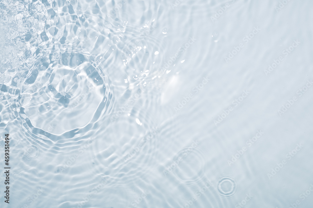 Light blue water background with circles from drops and stains all over the surface Light blue water background with circles from drops and stains all over the surface
