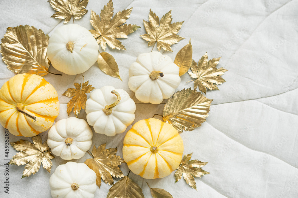 Sweet mini pumpkins and golden autumn leaves on a leaf-shaped blanket. Thanksgiving day decor. Sweet mini pumpkins and golden autumn leaves on a leaf-shaped blanket. Thanksgiving day decor.