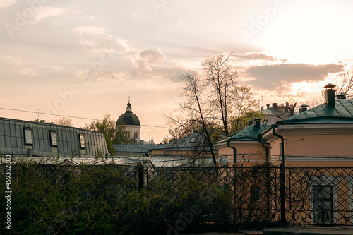 Photography A fence and plants in the morozov's garden against a moscow cityscape by summer