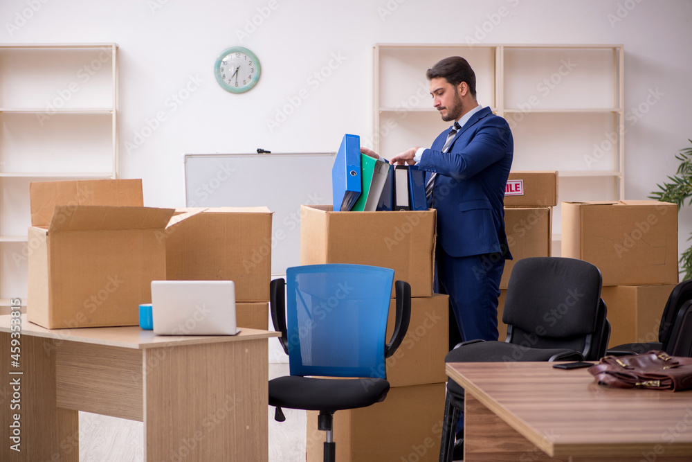 Young male employee in relocation concept Young male employee in relocation concept