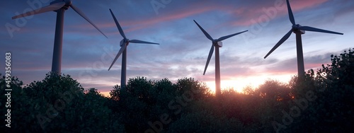Lush forest with wind turbines in the background.  photo