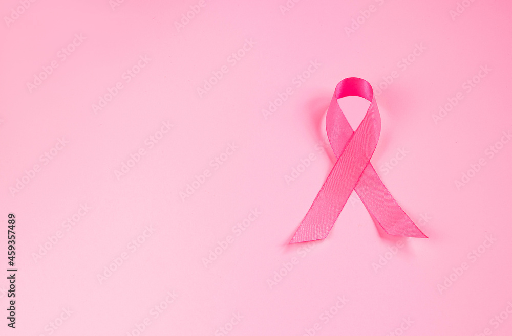 Pink ribbon on colored background. Breast Cancer Awareness Month symbol. Women's health care concept. Promotion of campaign to fight cancer. Pink ribbon on colored background. Breast Cancer Awareness Month symbol. Women's health care concept. Promotion of campaign to fight cancer.