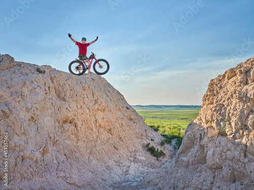 Senior man is riding a fat mountain bike in badlands of Pawnee National Grassland in northern Colorado