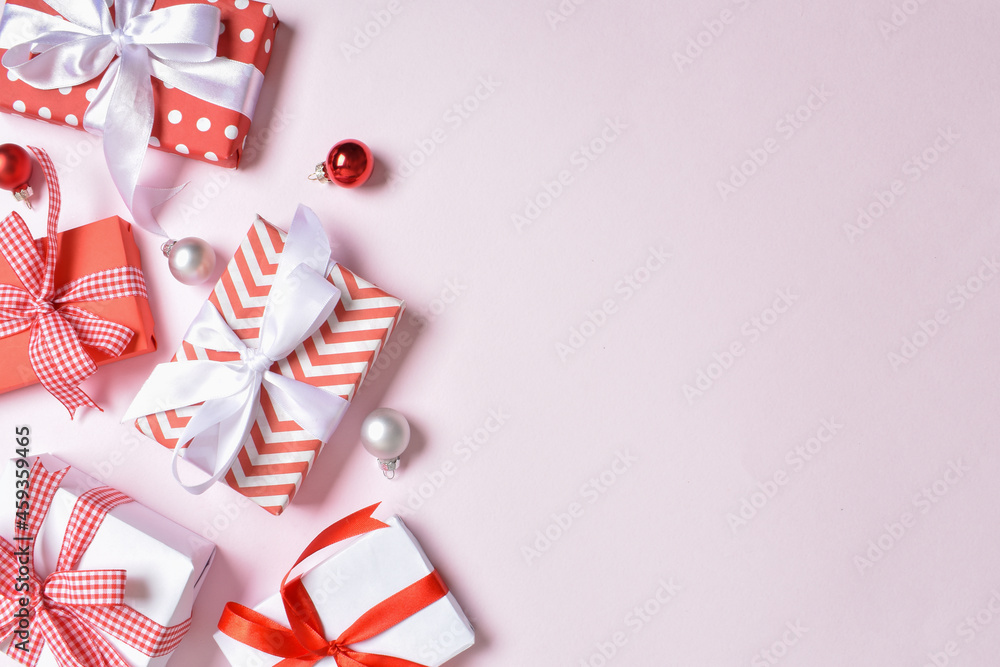 Fototapeta premium A bunch of red and white gifts on a pink background.