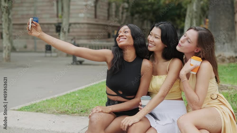 Multiethnic girlfriends taking selfie in city Multiethnic girlfriends taking selfie in city