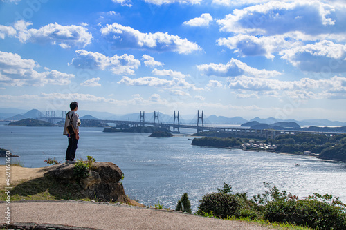Fotografía 瀬戸大橋を眺める男性の後ろ姿　岡山県倉敷市　An Asian man standing and looking at the view of Seto Ohashi bridge at Setonaikai, Inland Sea of Japan, in Kurashiki city, Okayama pref
